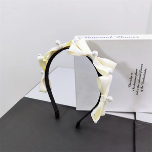 Elegant French style headband with cream satin bows and pearls on a black frame