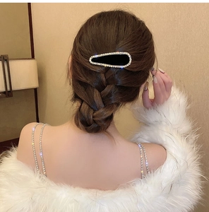 Gros plan d'une barrette noire en strass sur cheveux tressés pour un look élégant