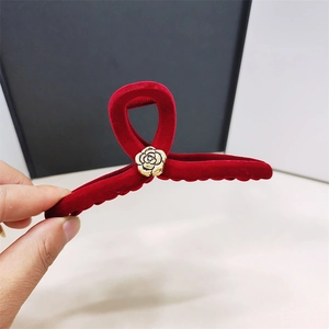 Elegant burgundy velvet hair claw clip featuring a vintage gold embossed rose decoration