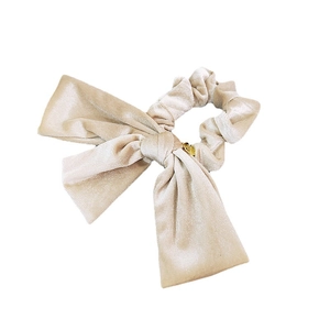 Elegant champagne velvet bow scrunchie with long ribbons and a gold metal charm