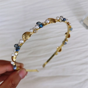 Elegant gold headband with pearls, navy rhinestones, and seashell ornaments for women