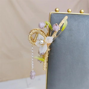 Golden metal hair claw with white flowers, purple lily of the valley and pearl tassels