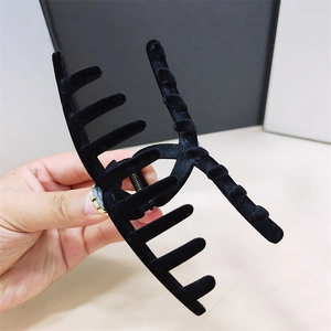 Detailed view of the large black velvet hair claw clip with strong metal spring