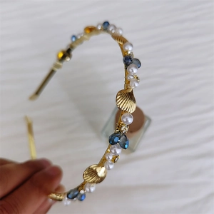 Elegant gold metal headband with white pearls, blue crystals, and sea shells