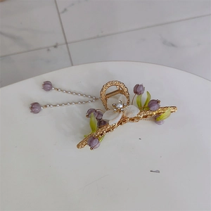 Elegant gold metal hair claw clip with purple lily of the valley and pearl tassels