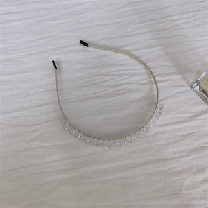 Detailed macro view of the silver metal headband with shimmering crystal leaf decorations