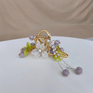 Exquisite golden hair claw with purple lily of the valley, white flowers and pearl tassels