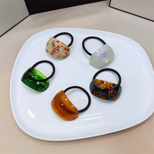Detailed set of 5 acetate ponytail holders in marble, amber, and iridescent finishes