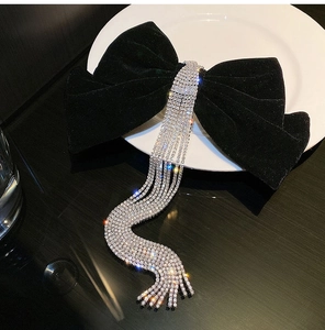 Large black velvet bow hair clip with sparkling rhinestone tassels for bridal hairstyle