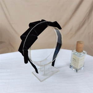 Elegant black velvet headband featuring ruffled design and sparkling rhinestone chain trim