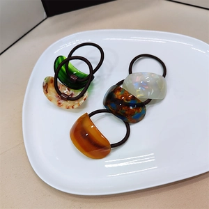 Set of four stylish acetate hair ties with half-round resin charms in various colors