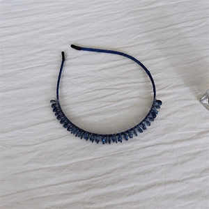 Detailed view of handmade navy blue beaded headband with crystal facets on silk base