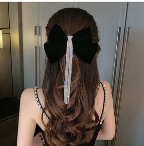 Detailed back view of a velvet bow hair clip with sparkling long diamond tassels