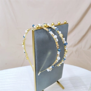 Macro view of gold starfish and shell headband with blue crystals and white pearls