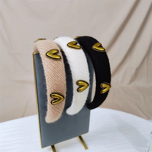 Three-piece knitted headband set with gold heart accents in beige white and black