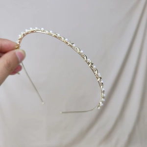 Elegant gold metal headband with white pearls and celestial star and moon ornaments