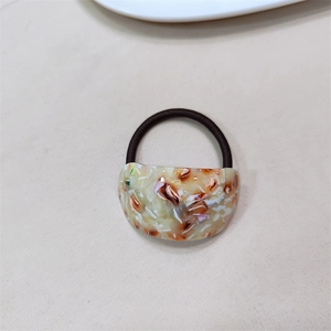 Minimalist marble pattern acetate semi-circle hair ring with brown elastic band on beige base