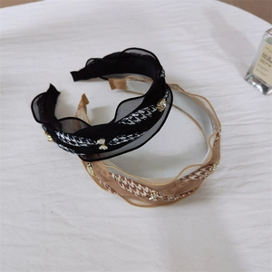 Close-up of pleated gauze headbands with houndstooth ribbon and rhinestone butterflies
