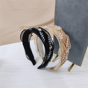Detail view of woven houndstooth headbands with sparkling rhinestones in black and champagne