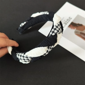 Detail of the black and white houndstooth cross braided fabric headband for women