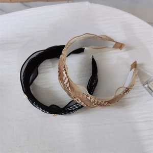 Houndstooth and black lace headband set with rhinestone accents on a white fabric base