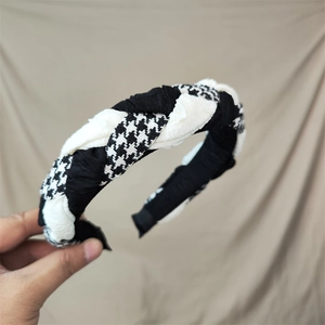 Detail of cross-woven houndstooth and black fabric headband with soft texture
