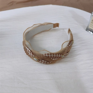 Close-up of houndstooth headband with layered tulle ruffles and shiny rhinestone accents