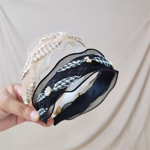Detail of ruffle organza headbands with houndstooth pattern and sparkling rhinestones