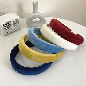 Macro shot of vintage velvet sponge headbands in deep blue, yellow, and red colors