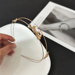 Detail of a golden double-layered floral headband featuring exquisite crystal butterflies