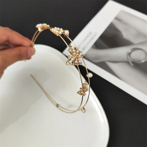 Detail shot of golden double-layer headband with hollow butterflies, pearls and crystals