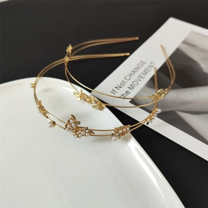 Close-up of golden butterfly headbands with sparkling rhinestones and elegant pearls