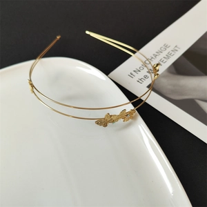 Detail of gold double-row headband with intricate butterflies and zircon crystals