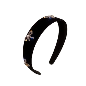 Elegant black velvet wide headband with sparkling silver bows and pearls on white background