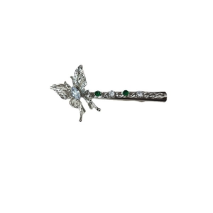 Silver butterfly hair clip with emerald zircon stones and textured metallic wings