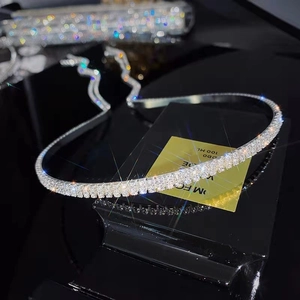 Detail of silver headband featuring three rows of sparkling rhinestones on slim metal