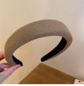Close-up of thick sponge headband with dark beige woven texture and non-slip lining