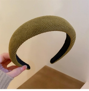 Detail of olive green ribbed padded headband showing thick sponge texture and elasticity