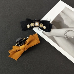 Detail of velvet and suede hair claws with elegant pearls and sparkling rhinestones