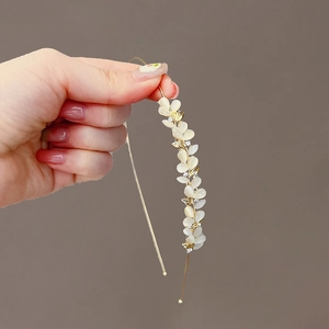 Elegant gold metal headband with cat eye opal petals and sparkling rhinestones