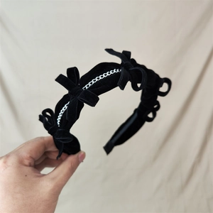 Vintage black velvet headband with three bows and silver chain detail for women