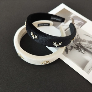 Detailed view of padded velvet headbands with rhinestone stars and handmade label