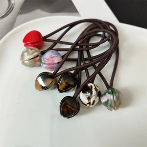 French tulip handmade resin flower hair ties set in assorted colors on a white plate