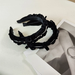 Detail of black velvet headbands with pearls, rhinestones, and silver chain accents