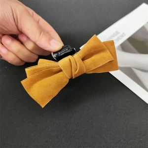 Detail of ginger yellow velvet bow hair claw clip made of premium suede fabric