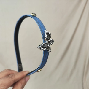 Blue denim headband featuring silver metal butterfly detail and contrast stitching