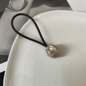 Macro shot of French style tulip hair tie with marble texture acrylic bead detail