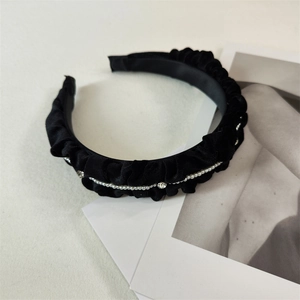 Detail of black velvet pleated headband with delicate pearl chain and sparkling rhinestones