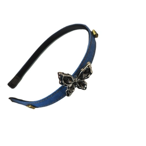 Denim blue headband with a large silver butterfly knot and golden metal studs