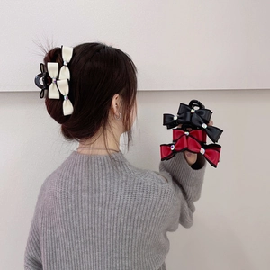 Elegant oversized layered bow hair claw clip with rhinestones in cream, red, and black